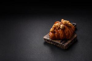 Sweet crispy croissant with salted caramel and glazed popcorn photo