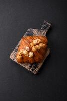Sweet crispy croissant with salted caramel and glazed popcorn photo