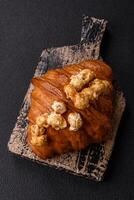 Sweet crispy croissant with salted caramel and glazed popcorn photo