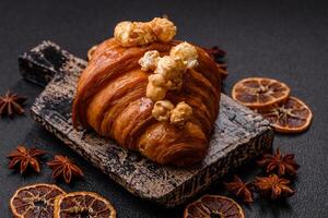 Sweet crispy croissant with salted caramel and glazed popcorn photo