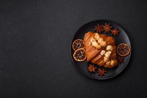 Sweet crispy croissant with salted caramel and glazed popcorn photo
