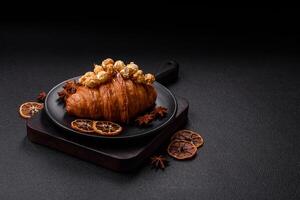Sweet crispy croissant with salted caramel and glazed popcorn photo
