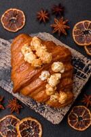 Sweet crispy croissant with salted caramel and glazed popcorn photo