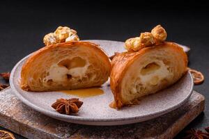 Sweet crispy croissant with salted caramel and glazed popcorn photo