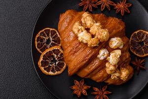 Sweet crispy croissant with salted caramel and glazed popcorn photo