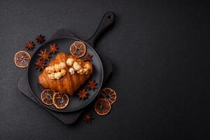 Sweet crispy croissant with salted caramel and glazed popcorn photo