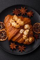 Sweet crispy croissant with salted caramel and glazed popcorn photo