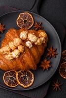 Sweet crispy croissant with salted caramel and glazed popcorn photo