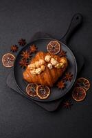 Sweet crispy croissant with salted caramel and glazed popcorn photo