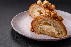 Sweet crispy croissant with salted caramel and glazed popcorn photo