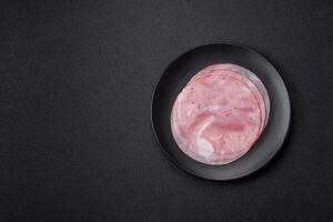 Ham cut into round slices with salt, spices and herbs photo