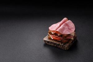 Sandwich with toast, ham, cheese, tomatoes, salt, spices and herbs photo