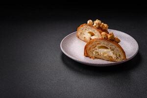 Sweet crispy croissant with salted caramel and glazed popcorn photo