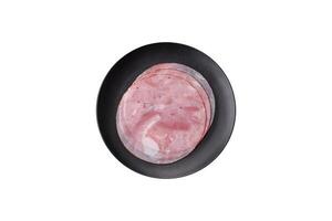 Ham cut into round slices with salt, spices and herbs photo