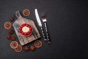 Sweet tartlet with raspberries and cream photo