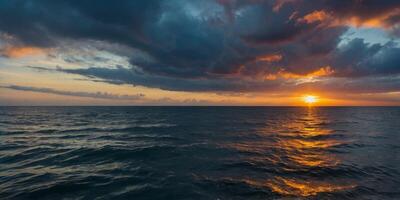 A serene ocean scene as the sunrise breaks through dramatic clouds casting a spectrum of colors reflected in the water. photo