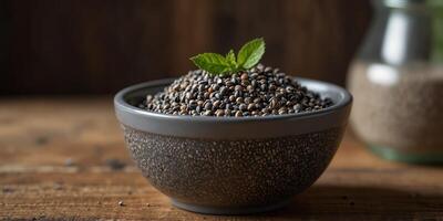 Chia seeds in a bowl displayed on a wooden surface with a blank area for additional content copy space image. photo