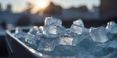 An ice bath filled with chunks of ice and water with a towel dd over the edge. photo