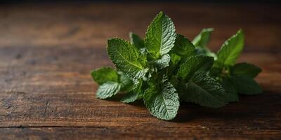 A Bundle of Fresh and Green Mint Leaves on wooden table for Healthy Nutrition. photo