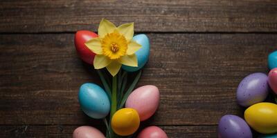 Heart daffodil and Easter eggs arranged on wooden surface with copy space image. photo