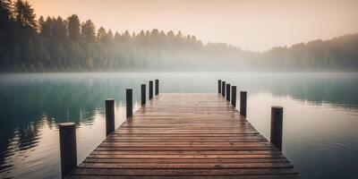 Foggy Lake with Wooden Dock Leading into Mist. photo