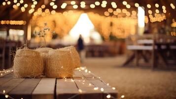 A community come together for a barn dance, with hay bales and string lights decorating the rustic space, to celebrate the successful harvest and share in a feast of homemade dishes. photo