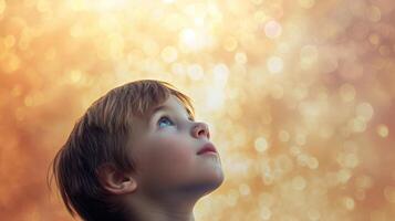 A young boy looking up at the sky his eyes wide and unseeing lost in his own thoughts photo