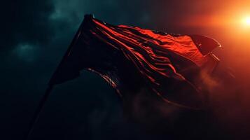 Closeup of the flag being held up against the dark night sky creating a striking contrast between light and dark photo