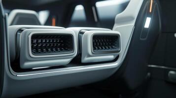 Detailed shot of the backseat air vents highlighting their dual function of providing both heating and cooling for pengers in the rear photo
