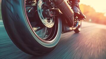 Detail shot of a motorcycles wheel in motion with the focus on the way the tire hugs the curves of the road photo