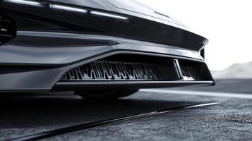 Closeup of the undercarriage of a family car demonstrating the aerodynamic design for improved airflow and reduced drag photo