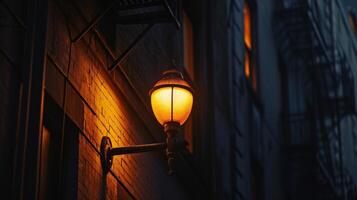 A dramatic closeup of a solitary street lamp its warm glow contrasting with the deep shadows of the surrounding buildings photo