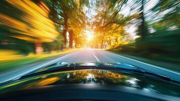 The blurred outline of a car against a background of blurred trees and foliage symbolizing a race through the winding countryside photo