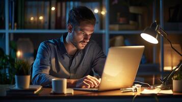 An employee at their desk working under the glow of a desk lamp that automatically turns off when the employee steps away thanks to smart energy management features photo