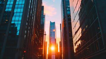 The sleek and angular silhouettes of office buildings stand out against the soft colors of the setting sun as a busy metropolis prepares for the night ahead photo