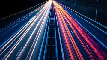 A closeup of the highway shows the intricate patterns created by the light streaks of vehicles ping by in a long exposure shot photo