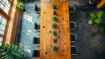 An overhead shot of a conference room table with several unobtrusive sensors embedded in the corners tracking occupancy and making it easy to optimize space usage photo