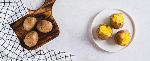 Appetizing jacket potatoes on a white plate on the table top view web banner photo