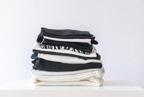 Stack of folded colorful clothes. Compact storage organizing photo