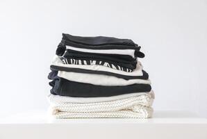 Stack of folded colorful clothes. Compact storage organizing photo