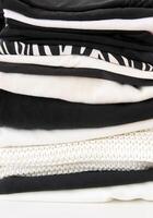 Stack of folded colorful clothes. Compact storage organizing photo
