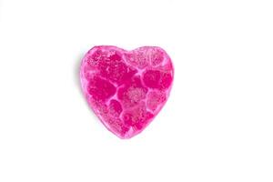 Heart shaped bar of soap on a light soft background. Top view. photo
