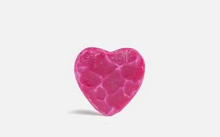 Heart shaped bar of soap on a light soft background. Top view. photo