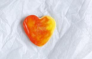 Heart shaped bar of soap on a light soft background. Top view. photo