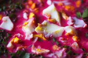 Cold beetroot soup with boiled eggs and greenery photo