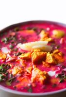 Cold beetroot soup with boiled eggs and greenery photo