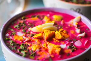 Cold beetroot soup with boiled eggs and greenery photo