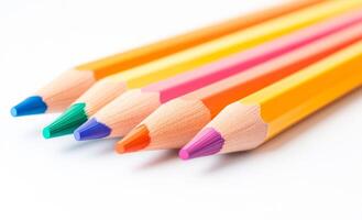 A row of colored pencils with a blue tip. The pencils are arranged in a row and are of different colors photo