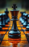 A black king chess piece is standing on a checkered board. Concept of power and authority, as the king is the most important piece on the board. The checkered background adds a sense of order photo