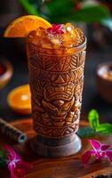 A drink in a wooden cup with a flower on top. The drink is a tropical cocktail with a slice of orange on top photo